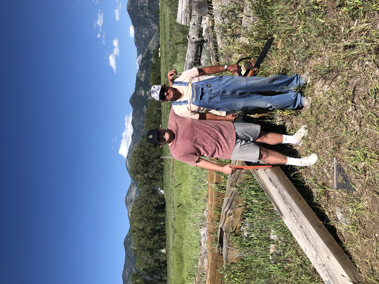 The founder's father standing with his grandson in a mountain field
